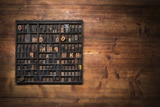 print still life with lettering, brushes and other tools on a wooden background