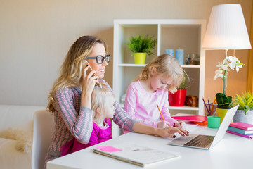 Mom with two daughters working from home