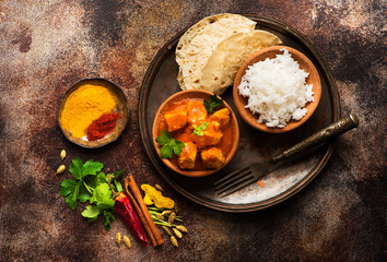 Indian meat dish with rice and naan bread. Chicken tikka masala spicy.