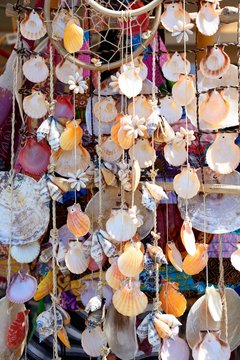 Various stringed shell ornaments hanging in the marina area, Albufeira, Portugal.