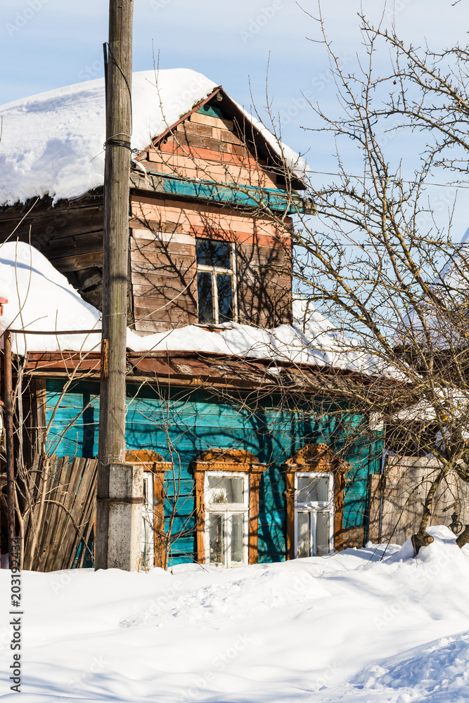 Sticker snow-covered old urban wooden house in Suzdal