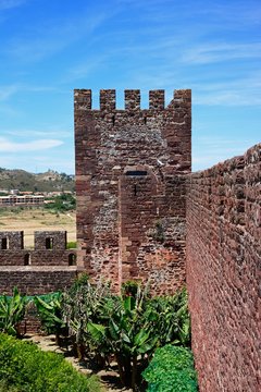 Medieval castle battlements and tower seen from inside the coutryard, Silves, Portugal.
