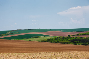 Fototapeta na wymiar Agricultural land, varied terrain. Spring Landscape in the Danube Plain Bulgaria.
