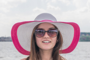 Pretty girl in sunglasses and hat