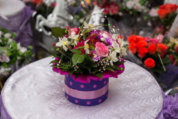 bunch of different flowers on a table at a wedding ceremony closeup.