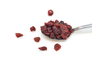 Dried cranberries in a spoon on white background - isolated