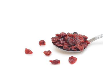 Dried cranberries in a spoon on white background - isolated