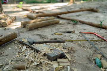Axe and other building tools lies on the ground in the jungle