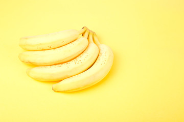 Banana on yellow paper background.