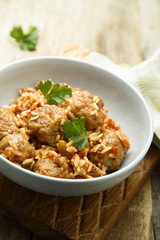 Homemade meatballs with rice, tomato and fresh parsley