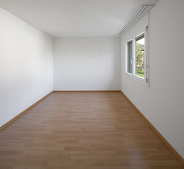 Empty room with parquet and window
