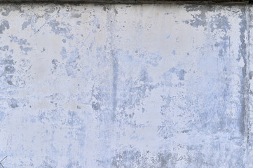 Part of the concrete wall with loose plaster of the old building. Background