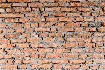 Fototapeta premium Part of the red brick walls of the old building. Sharp and contrast with stronger shadows top of the photo