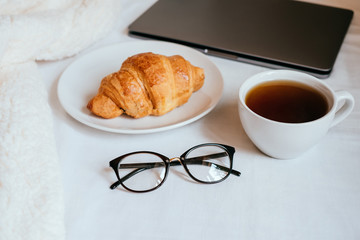 Coffee and croissant in bed