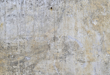Part of the concrete wall with loose plaster of the old building. Background