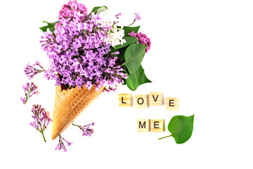 Flowers composition. Lilac in waffle cone. Flat lay, top view, copy space. Concept of proposal, love and tenderness.