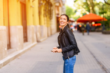 A happy young woman enjoying the autumn in a Central European ci