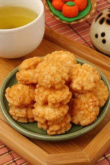 Japanese senbei and green tea on a tray,