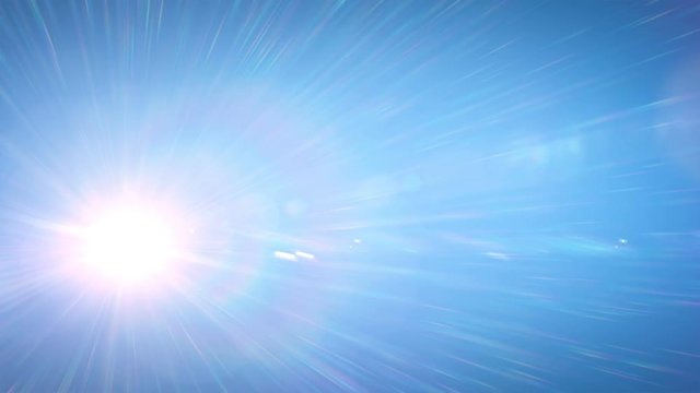 Beautiful Bright Sun Shining Moving Across the Clear Blue Sky with Spectral Rays in Time Lapse. 3d Animation with Flares and Spectrum. Nature and Weather Concept. 4k UHD 3840x2160.