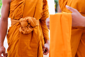 Yellow robe of Buddhist monks, Closeup on buddhist monk