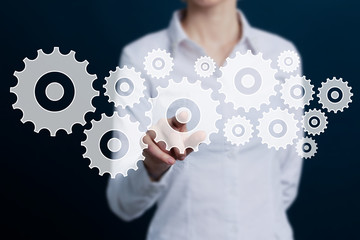 View of a Businessman touching technology interface with gear engineering wheel setting