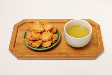 Japanese senbei and green tea on a tray,