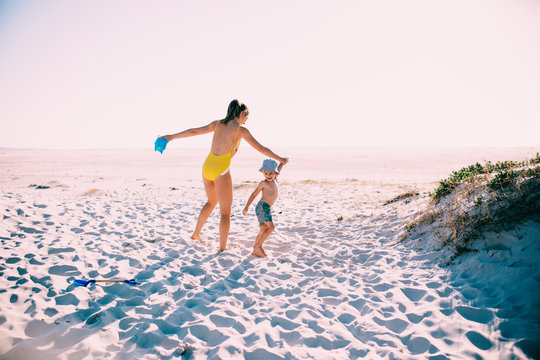 caucasian mother and son having fun at the beach