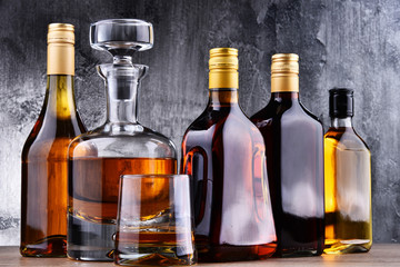 Carafe and bottles of assorted alcoholic beverages.