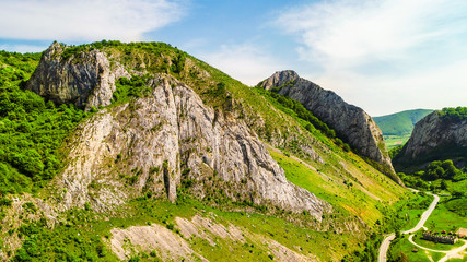 Aerial view of Valisoarei Gorge of Romania on a sunny day with cliffs