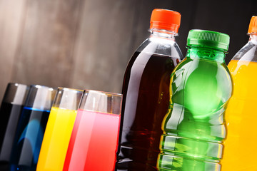 Glasses and bottles of assorted carbonated soft drinks