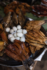 Grilled fish lies in the local Cambodian market. 