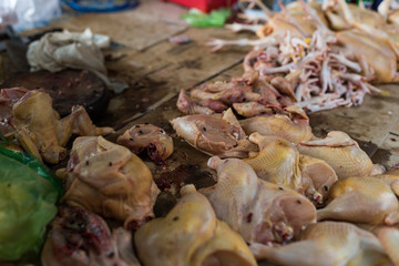 Cambodian local street food market with fresh chicken meat lies at open air