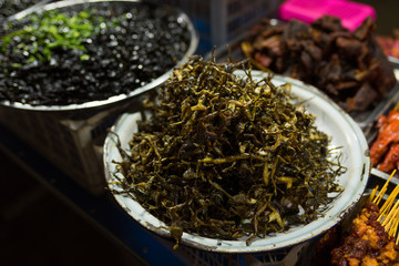 Cambodian night street food market with dried and grilled  frog