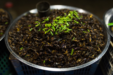 Cambodian night street food market with grilled  grasshopper