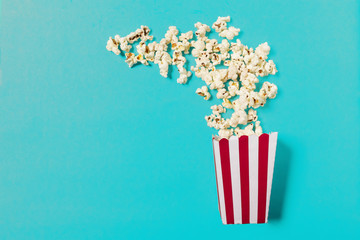 popcorn on color background