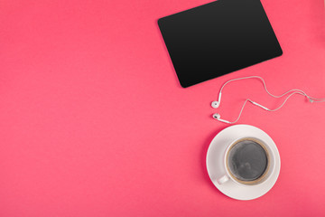 Digital tablet with blank screen and cup of coffee