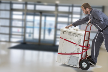 Delivery man pushing hand truck washing machine home appliance