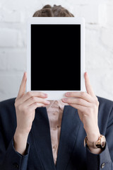 businesswoman in suit holding digital tablet with copy space