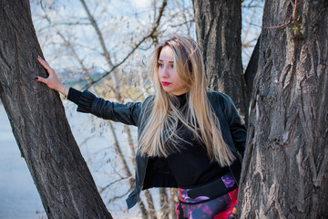 Pretty nice and stylish modern young woman at city park on a walk  