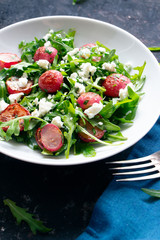 Arugula salad with roasted radishes and feta cheese