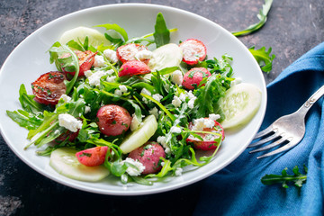 Arugula salad with roasted radishes, cucumber and feta cheese