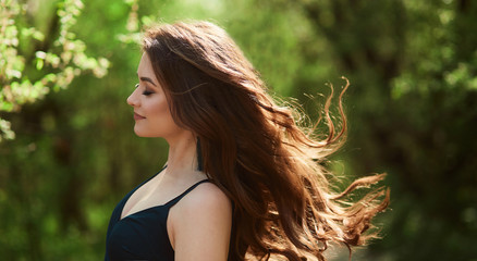 The beautiful girl stands in the park