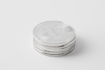 close-up shot of stacked bitcoins on white surface