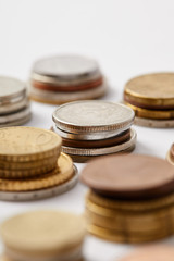 close-up shot of stacks of coins on white