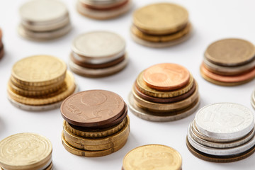 close-up shot of stacks of coins from various countries on white