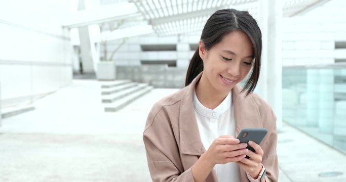 Woman using mobile phone at outdoor