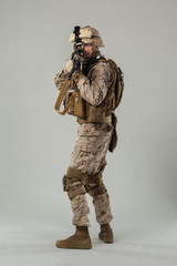 Soldier in camouflage holding rifle