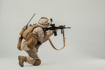 Soldier in camouflage holding rifle