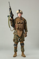 Soldier in camouflage holding rifle