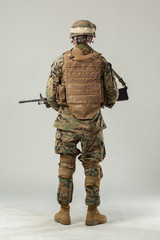 Soldier in camouflage holding rifle